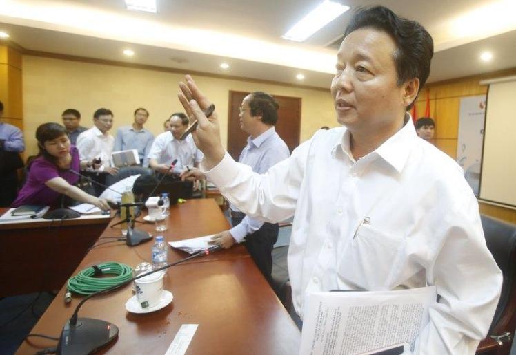 Ha gestures while leaving a meeting in Hanoi